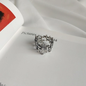 Macro detail of gothic vintage silver cross crown ring with intricate relief engraving