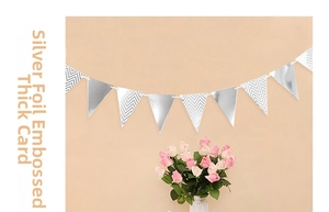 Detail of silver foiled triangle banner made of thick paper for party decorations