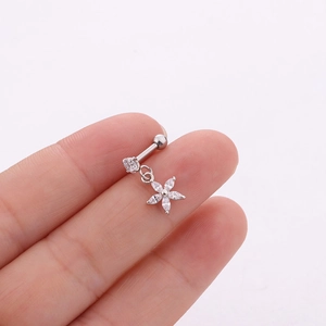 Macro shot of silver stainless steel flower piercing earring with zircon crystals detail