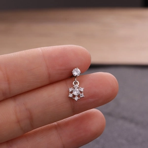 Macro view of silver snowflake zircon earring with micro-paved crystals on stainless steel