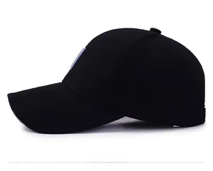 Side view of black twill cotton baseball cap with curved brim and blue logo patch