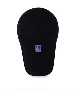 Detail shot of black cotton twill baseball cap with blue embroidered GOLF square patch