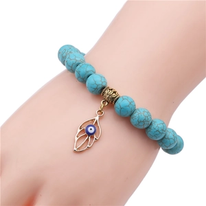 10mm turquoise beaded bracelet with vintage gold leaf charm and blue evil eye detail