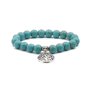 Detail of 10mm turquoise beads with tree of life charm on an elastic bracelet