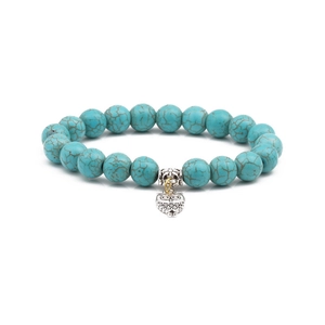 Close-up of 10mm turquoise beaded bracelet featuring a silver owl charm and hollow spacer