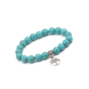 Close-up of 10mm turquoise beaded bracelet with silver tree of life charm and beads