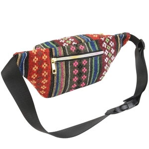 Detail of bohemian waist bag featuring colorful woven patterns and adjustable black strap
