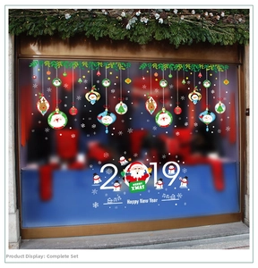 Detail of Christmas Santa train window decals on store glass with snowmen and reindeer