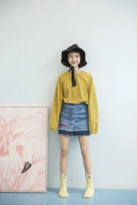 Full view of casual striped yellow shirt and blue denim skirt with cute monster socks