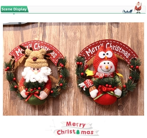 Detail of Christmas wreaths featuring Santa, reindeer, and snowman dolls on pine branches