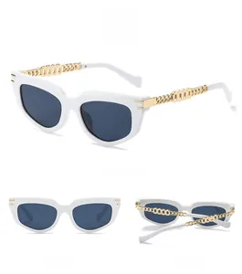 Detailed views of white cat-eye sunglasses with gold metal chain temples and grey lenses