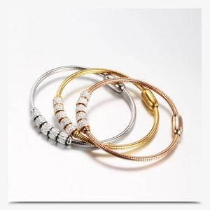 Detailed view of three-color snake bone chain bracelets with crystal encrusted sliders