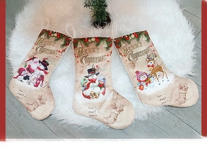 Close-up of vintage Christmas stockings with Santa and snowman prints on soft plush rug