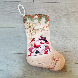 Christmas stocking with Merry Christmas print and festive patterns on a wood background