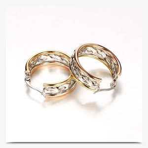 Close-up of tricolor gold woven 304 stainless steel hoop earrings for women