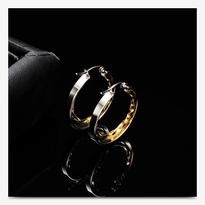 Detailed view of 28mm hollow double-layer round earrings with gold and silver finish