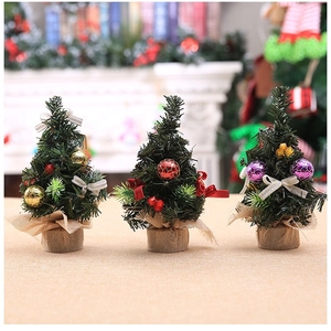 Three 20cm mini Christmas trees in burlap pots with festive baubles and bows