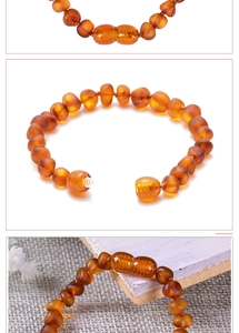 Detail of Baltic amber baby bracelet with a secure screw clasp and orange beads