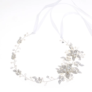 Detail of silver bridal hair vine with rhinestones, pearls and white ribbon