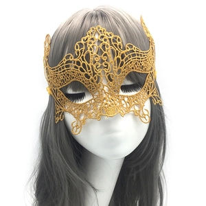 Close-up of golden hollow lace phoenix masquerade mask with intricate floral embroidery