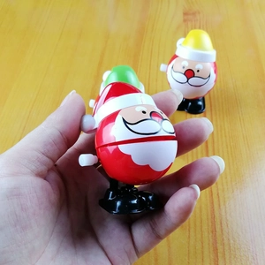 Close-up of wind-up Santa Claus jumping toys with clockwork mechanism and colorful plastic