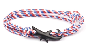 Macro shot of nautical braided rope bracelet with matte black shark hook clasp detail