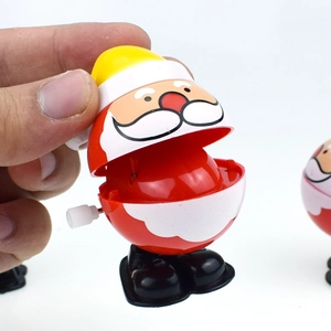 Detail of wind-up Santa Claus toy showing open mouth mechanism on white background