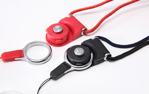 Detailed view of red and black quick release buckles with metal rings and nylon lanyards