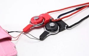 Detail shot of durable red and black lanyard quick-release buckles with metal buttons