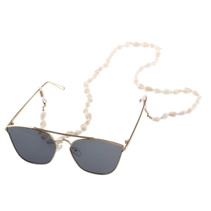 Sunglasses with golden frame and white natural seashell lanyard on a white background