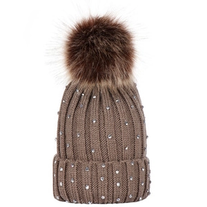 Detailed view of the brown knitted baby hat featuring sparkly rhinestones and fluffy pom