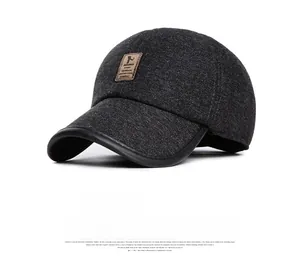 Detail of dark grey winter baseball cap showing thick wool fabric and leather logo