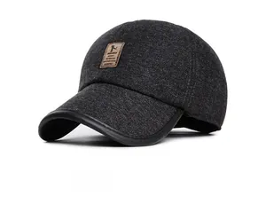 Detailed close-up of dark grey wool baseball cap with leather brim and brand tag