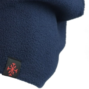 Detail of navy blue fleece fabric with black label featuring a red snowflake embroidery