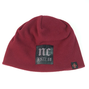 Detail of burgundy fleece beanie showing soft texture and gothic style leather patch