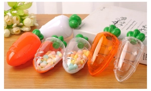 Carrot-shaped creative candy storage boxes in diverse colors on a wooden table