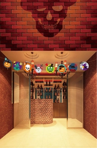 Detailed view of Halloween paper banner hanging in a decorated party room entrance