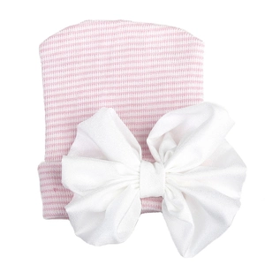 Detail of baby knitted hat with pink and white stripes and a large white chiffon bow