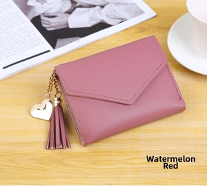 Watermelon red faux leather wallet detail with gold heart pendant and tassel accent