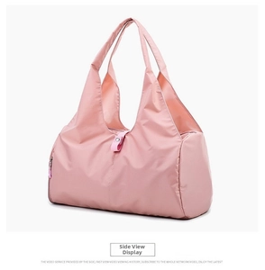 Close-up of pink waterproof nylon yoga bag with durable handles and side snap detail