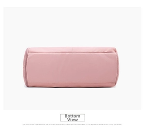 Detail view of pink yoga travel bag base with reinforced stitching and zipper closure