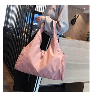 Pink waterproof yoga travel bag with large capacity shown in a modern lifestyle setting