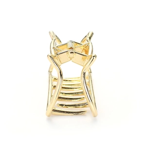 Close-up of a polished golden cat-shaped metal hair claw clip on a white background