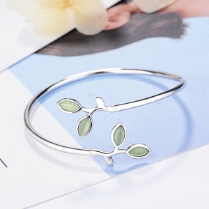 Silver leaf cuff bracelet with green cat-eye stone, minimalist nature-inspired jewelry