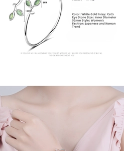 Detail view of silver bud bracelet with cat-eye stone leaf and 52mm inner diameter