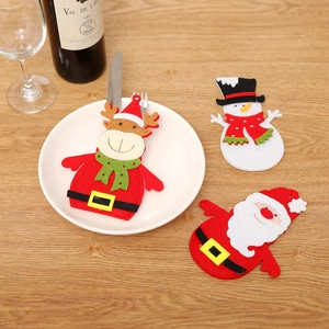 Christmas felt cutlery holders featuring Santa, snowman, and reindeer on a wooden table