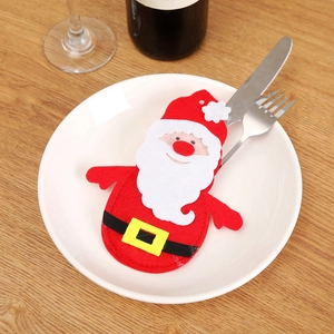 Santa Claus themed cutlery holder for Christmas table setting featuring festive red felt