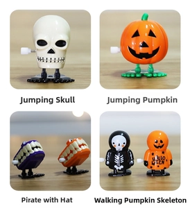 Detail of four Halloween wind-up toys including skull and pumpkin figures on wood