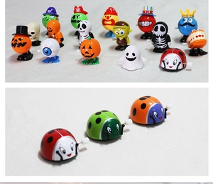 Close-up of assorted plastic wind-up toys including Halloween pumpkins and ladybugs