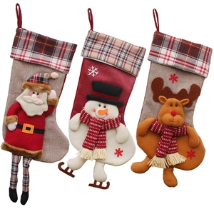 Three festive Christmas stockings featuring Santa, Snowman, and Reindeer in burlap and felt